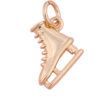 A gold ice skate charm set against a white background