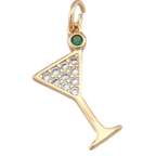 A gold martini glass charm pendant featuring a small green cabochon stone at the top and a row of clear pavé-set stones across the triangular bowl, shown on a plain white background.